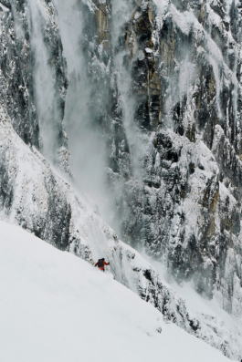 Man skiing off piste with a frozen, icy, mountain rocky wall behind him Ross Woodhall - Action & Lifestyle Photography