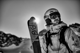 Skier with PFD skis looking out to the distance, image in black and white. skier wearing backpack, helmet and googles. Ross Woodhall - Action & Lifestyle Photography