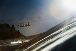 La Grave, telecabine with skier below skiing off piste, image in black and white. Ross Woodhall - Action & Lifestyle Photography