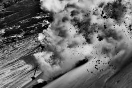 Black and white image of a skier off piste covered in a spray of snow. Ross Woodhall - Action & Lifestyle Photography