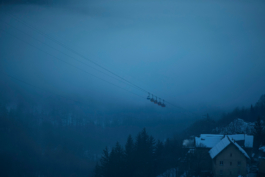 moody cloudy picture of skiing cable cars hanging above a village called La Grave, mountain called Le Meije. In the Massif des écrins range Ross Woodhall - Action & Lifestyle Photography