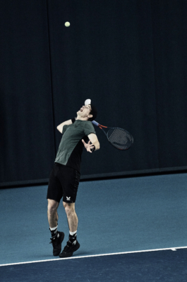 UK tennis player Andy Murray. In action after taking a serve, wearing Andy Murray Castore AMC tennis clothing, including arm sweatbands. shot at National Tennis centre in London Ross Woodhall - Action & Lifestyle Photography