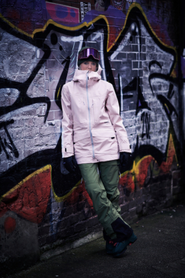Female Skier posing in Manchester side street fully kitted out leaning against a graffiti bricked wall. Ross Woodhall - Action & Lifestyle Photography