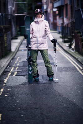 Female Skier posing in Manchester side street fully kitted out with skis and poles. Ross Woodhall - Action & Lifestyle Photography