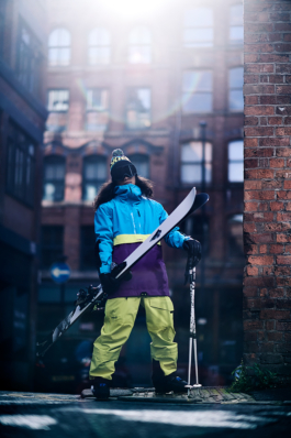 Male Skier posing in Manchester side street fully kitted out with skis and poles. Ross Woodhall - Action & Lifestyle Photography