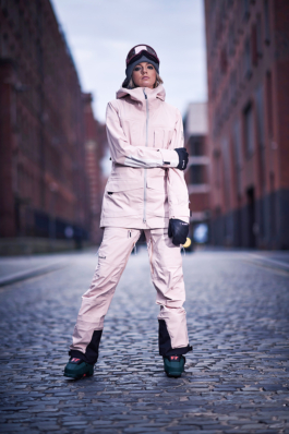 Woman wearing full ski wear on a cobbled street in Manchester with ski boots, gloves and googles Ross Woodhall - Action & Lifestyle Photography