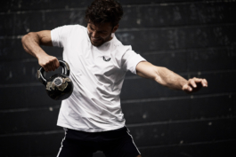 Man working out with kettlebell wearing Castore clothing. Ross Woodhall - Action & Lifestyle Photography