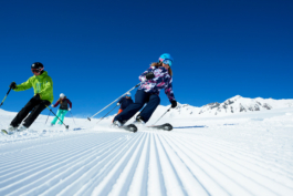 four skiers, skiing down a new groomed slope. Ross Woodhall - Action & Lifestyle Photography