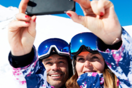 a couple of skiers taking a selfie on the slope. Ross Woodhall - Action & Lifestyle Photography