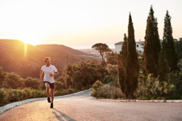 one male runner, jogging up hill, in european setting, outdoor lifestyle. Ross Woodhall - Action & Lifestyle Photography