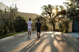 two male runners, walking on a quiet road. outdoor lifestyle. european. Ross Woodhall - Action & Lifestyle Photography