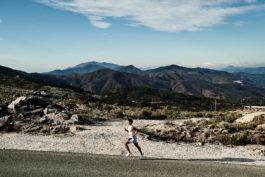 male runner, jogging up a road, with hills in background, outdoor lifestyle, european. Ross Woodhall - Action & Lifestyle Photography