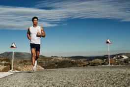 male runner jogging up a steep hill wearing Castore. Outdoor lifestyle. Ross Woodhall - Action & Lifestyle Photography