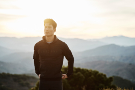 male runner, wearing Castore hoody with hills in background. European. Ross Woodhall - Action & Lifestyle Photography