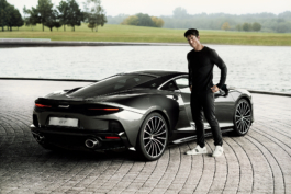 Man standing by Mclaren car, at their home showroom by a lake. Ross Woodhall - Action & Lifestyle Photography