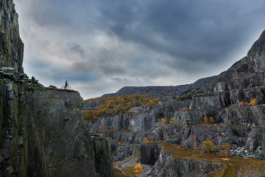 Mountain biker on a cliff ridge in disused quarry. Ross Woodhall - Action & Lifestyle Photography