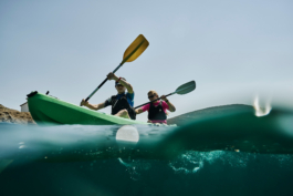 two sea kayakers paddling, taken from in the water. Ross Woodhall - Action & Lifestyle Photography