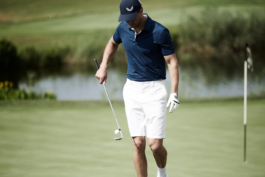 Man playing golf, wearing Castore clothing, including a matching cap. Walking away from putting green, bouncing ball off his golf club. Ross Woodhall - Action & Lifestyle Photography