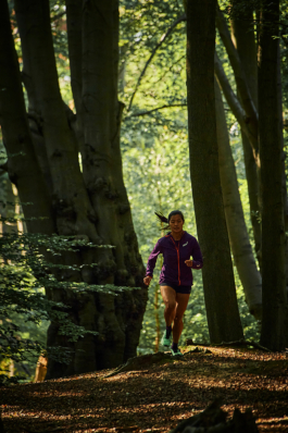 female jogger in a woodland setting. Ross Woodhall - Action & Lifestyle Photography
