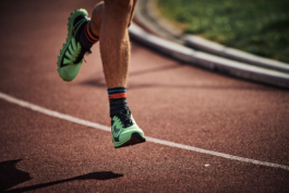 close up of runners feet mid air on a running track. Ross Woodhall - Action & Lifestyle Photography