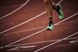 close up of runners feet mid air on a running track. Ross Woodhall - Action & Lifestyle Photography