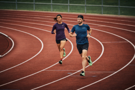 two runners running on a running track. Ross Woodhall - Action & Lifestyle Photography