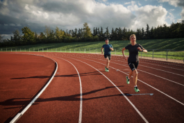 two runners on a running track. Ross Woodhall - Action & Lifestyle Photography