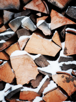 Close up picture of a pile of logs with dusting of snow Ross Woodhall - Action & Lifestyle Photography