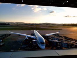 picture of aeroplane with walkway connected, taken from airport window. Ross Woodhall - Action & Lifestyle Photography