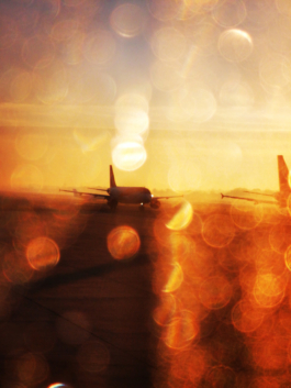view out of a plane window of a plane in the sunset with water droplets. Ross Woodhall - Action & Lifestyle Photography