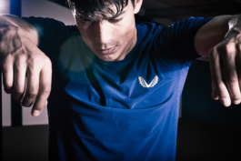 man resting between gym equipment, wearing Castore. Ross Woodhall - Action & Lifestyle Photography