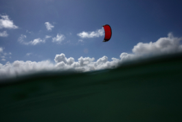 Red kite surf sail seen from in the water. Ross Woodhall - Action & Lifestyle Photography