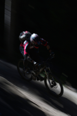 Mountain biker a speed wearing full mountain bike gear. outdoor sports in motion. Ross Woodhall - Action & Lifestyle Photography