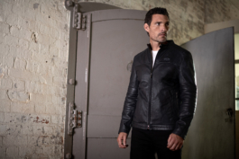Man wearing leather zip through lightweight jacket with Jaguar branded logo on left hand side of the chest. Ross Woodhall - Action & Lifestyle Photography