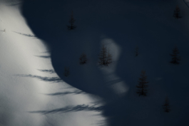Image of shadows from the mountain and tree shadows appearing on the snow. Ross Woodhall - Action & Lifestyle Photography