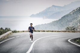 male, outside exercising, towards the sea. running on the road. Ross Woodhall - Action & Lifestyle Photography
