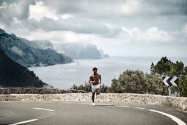 male, outside exercising, taking the view in towards the sea. Ross Woodhall - Action & Lifestyle Photography