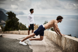 two males, outside exercising, taking the view in towards the sea. Ross Woodhall - Action & Lifestyle Photography