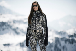 ski lifestyle, woman wearing one piece ski outfit, lepoard print. wearing sunglasses and hair down. Ross Woodhall - Action & Lifestyle Photography
