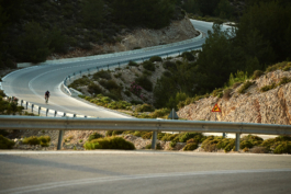 Windy road with a solo cyclist. Ross Woodhall - Action & Lifestyle Photography