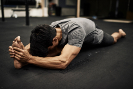man stretching in gym, yoga pose, Pilates, wearing Castore Ross Woodhall - Action & Lifestyle Photography