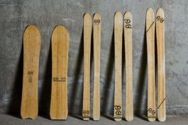 Collection of PFD designed bamboo skis and snowboards, leaning against a concrete wall. Ross Woodhall - Action & Lifestyle Photography