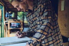 Main working on a ski design in a notebook in his workshop. Ross Woodhall - Action & Lifestyle Photography