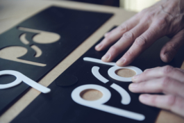 Man working on pair of bamboo skis placing his PFD logo Ross Woodhall - Action & Lifestyle Photography