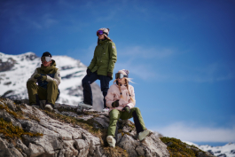 skiers taking a break and hanging out on some rocks, wearing googles and woolly hats. Ross Woodhall - Action & Lifestyle Photography