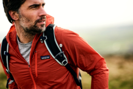 Close up of a man out hiking/walking wearing a light Patagonia jacket and backpack. Ross Woodhall - Action & Lifestyle Photography
