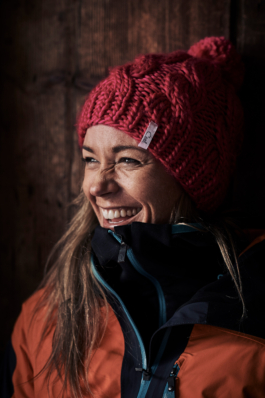 woman wearing a woolly hat laughing. ski lifestyle. Ross Woodhall - Action & Lifestyle Photography