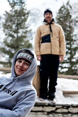 two skiers being playful, posing in front of the camera Ross Woodhall - Action & Lifestyle Photography