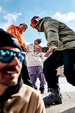 Four skiers being playful in their ski clothing towards the camera. Ross Woodhall - Action & Lifestyle Photography