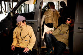 A man and a woman hanging out by a van, in ski clothing with sunglasses on. Ross Woodhall - Action & Lifestyle Photography